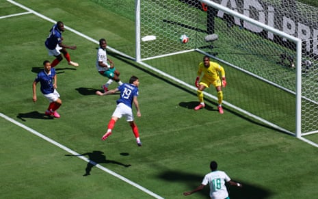 France's Theo Hernandez heads clear.