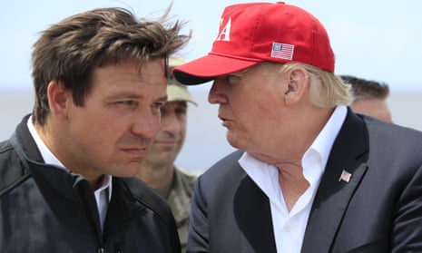 Donald Trump talks to Ron DeSantis during a visit to Lake Okeechobee, Florida, in March 2019.