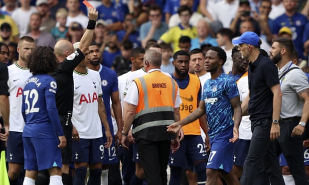 Referee Anthony Taylor shows a red card to Thomas Tuchel