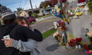 People mourn near a makeshift memorial in December 2016 following the fire.