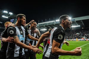 Isaac Hayden (right) and his Newcastle teammates celebrate their late winner.
