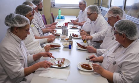 Members of the VW production team eat currywurst during the daily morning tasting session at the Wolfsburg plant.