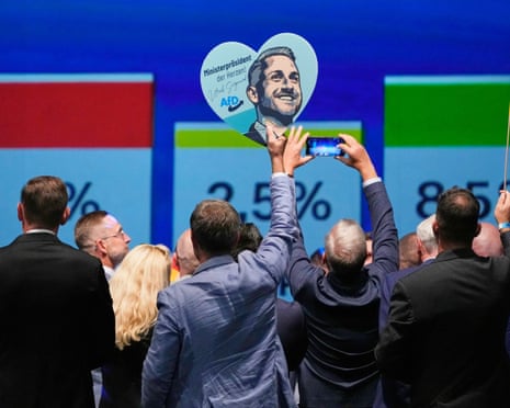 Party members celebrate with a sign of AfD top candidate Ulrich Siegmund after the first results in the Saxony-Anhalt state elections