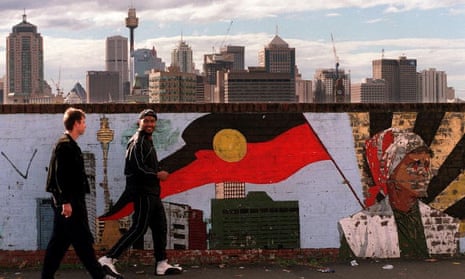 Two men walk past a mural depicting the Aboriginal flag in Sydney. ‘If it’s something people want, Aboriginal people have less of it, and if it’s something people don’t want Aboriginal people have more,’ said Jonathan Rudin.