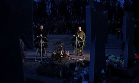 Poland’s president Andrzej Duda and Ukraine’s counterpart Zelenskiy commemorate fallen Ukrainian defenders at a cemetery in Lviv.