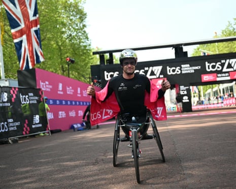 Marcel Hug poses after winning the men's wheelchair race at the London Marathon