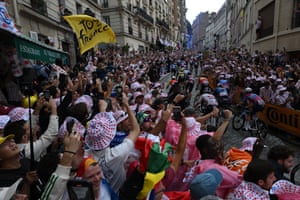 Fans cheer the peloton as it climbs Rue Lepic on the Cote de la Butte Montmatre close to the Basilique du Sacre-Coeur.