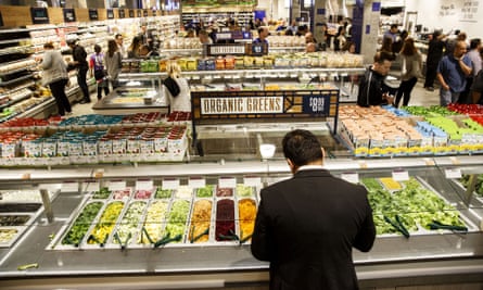 A customer builds a salad at a supermarket in Los Angeles