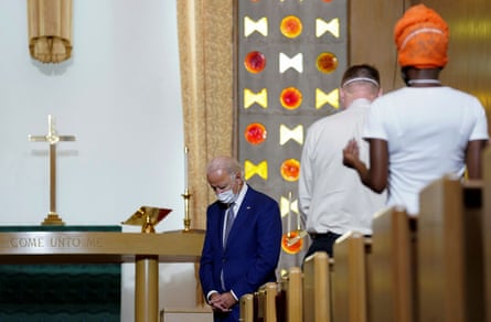 Joe Biden bows his head in prayer during a community meeting at Grace Lutheran church in Kenosha, Wisconsin.