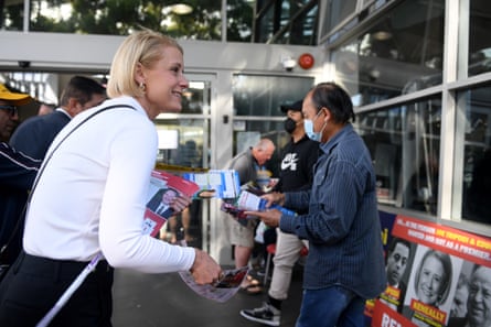 Labor’s Kristina Keneally hands out how to vote cards at an early voting centre in Fowler during the election campaign.