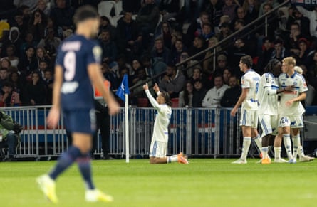 Diego Moreira points his fingers in the air while on his knees after scoring during the Ligue 1 match between Paris Saint-Germain and Strasbourg