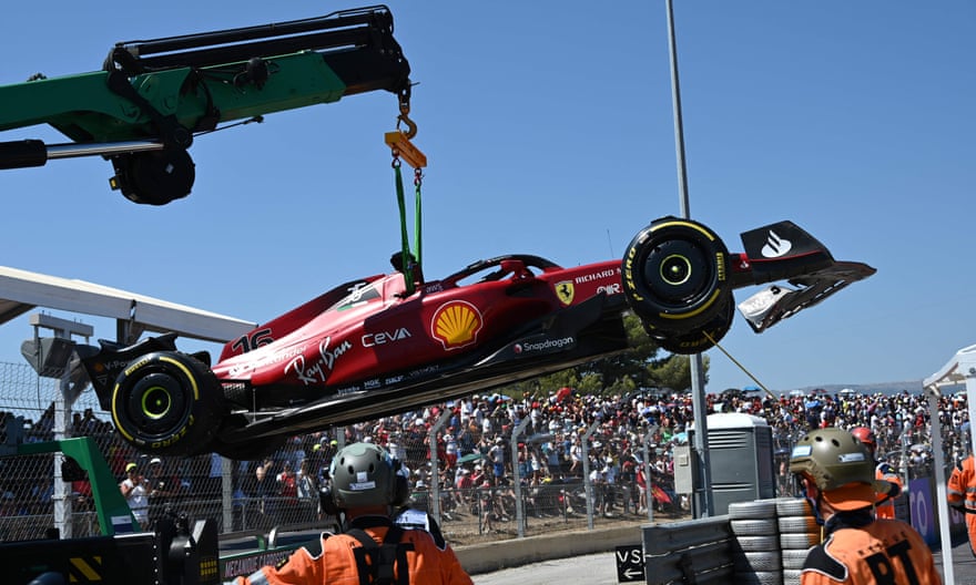 Charles Leclerc’s Ferrari is lifted from the circuit.