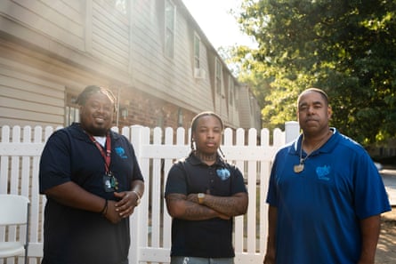Three men stand outside