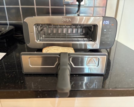 A Ninja Foodi 3-in-1 toaster, grill & panini press on a kitchen worktop