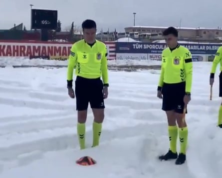 Turkish officials test the pitch before a match is snowed off