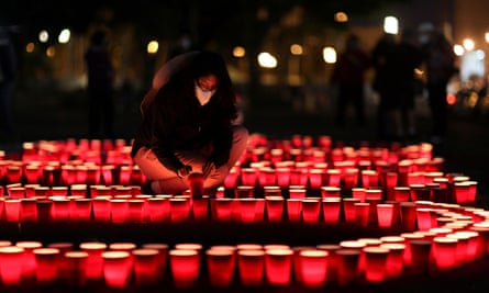 A woman lights candles in Guatemala City in honor of the people who have died from coronavirus.