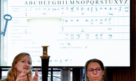 Cécile Pierrot (L) and university lecturer in modern history Camille Desenclos (R) explain the decoding process of an encrypted letter from Charles V.