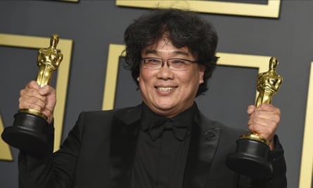 Bong Joon-ho with two of Parasite’s four Oscars.