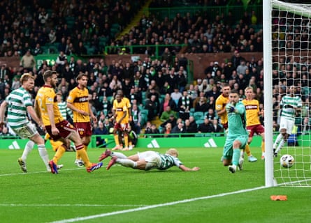 Celtic’s Daizen Maeda dives low to head an added-time winner against Motherwell.