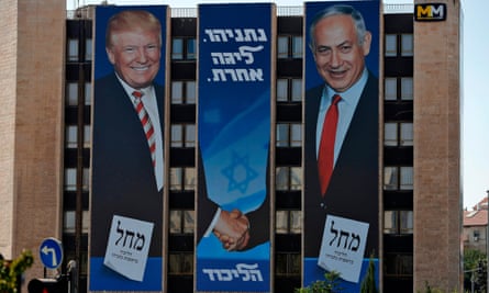 An Israeli election banner for the Likud party showing Donald Trump shaking hands with Benjamin Netanyahu hangs on a building in Jerusalem.
