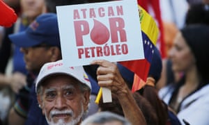 A man has a sign reading in Spanish & # 39; r oil in March in support of the state oil company PDVSA in Caracas on Thursday.