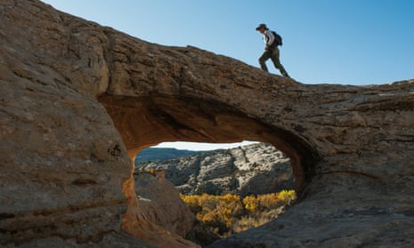 FILE PHOTO: A man walks over a natural bridge at Butler Wash in Bears Ears National Monument near Blanding, Utah, U.S., October 27, 2017. REUTERS/Andrew Cullen/File Photo