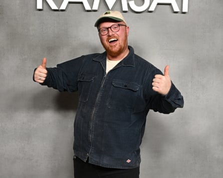 Young man stands with his two thumbs up and a big grin