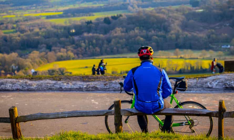 Cyclist taking a break and admiring beautiful Surrey Hills
