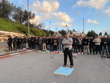 Worshippers pray outside the Old City on Friday morning.