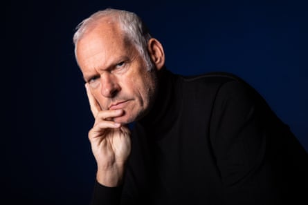 Martin McDonagh in a black polo neck poses against a dark background.