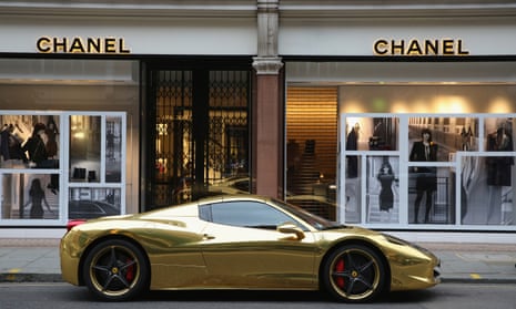 a gold sports car outside a Chanel shop
