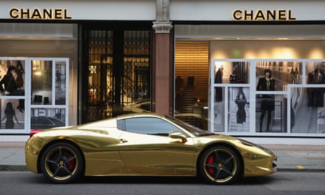 A gold Ferrari is parked outside Chanel in London