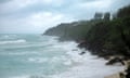 waves crash into the shore of a beach