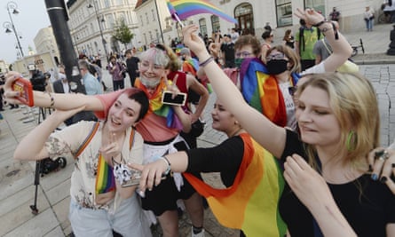 People with rainbow flags take part in a flashmob in front of the presidential palace in Warsaw.