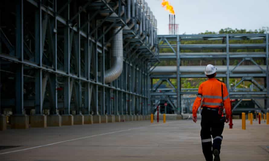 A worker walks through the Queensland Curtis LNG project site
