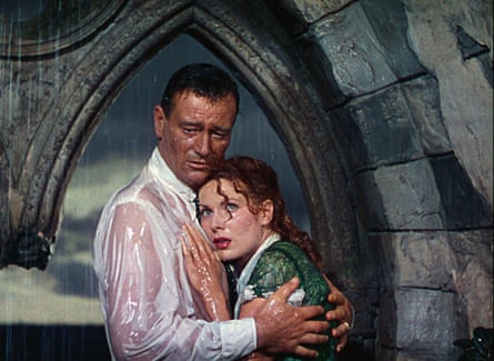 A still photo of John Wayne and Maureen O’Hara embracing in the rain in the film The Quiet Man