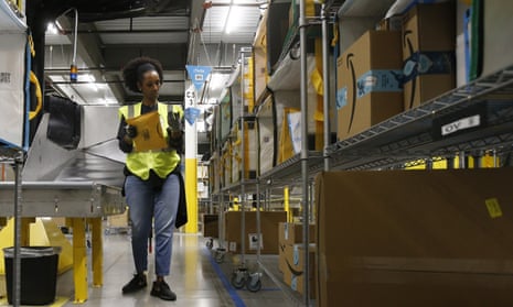 A worker sorts packages at an Amazon warehouse facility in Goodyear, Arizona.
