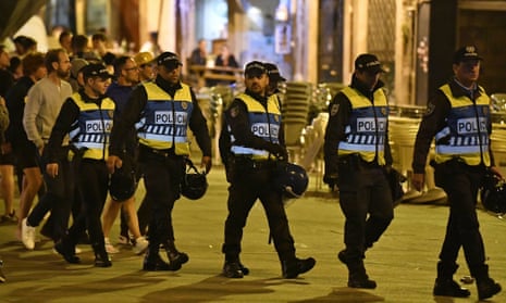 Police officers in Porto walk into position to monitor England supporters before the Nations League game against the Netherlands.