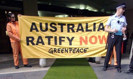 Greenpeace demonstrators, one dressed as a policeman, protest outside prime minister John Howard Sydney office in 2001