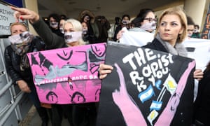 Women with placcards outside Famagusta district court last week.
