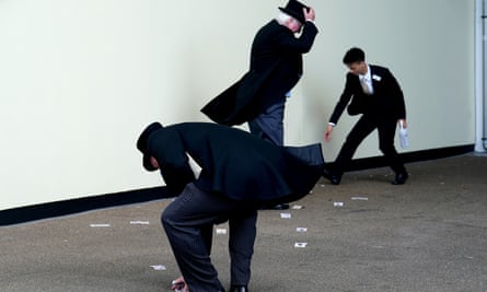 Men in top hats picking up banknotes from the ground
