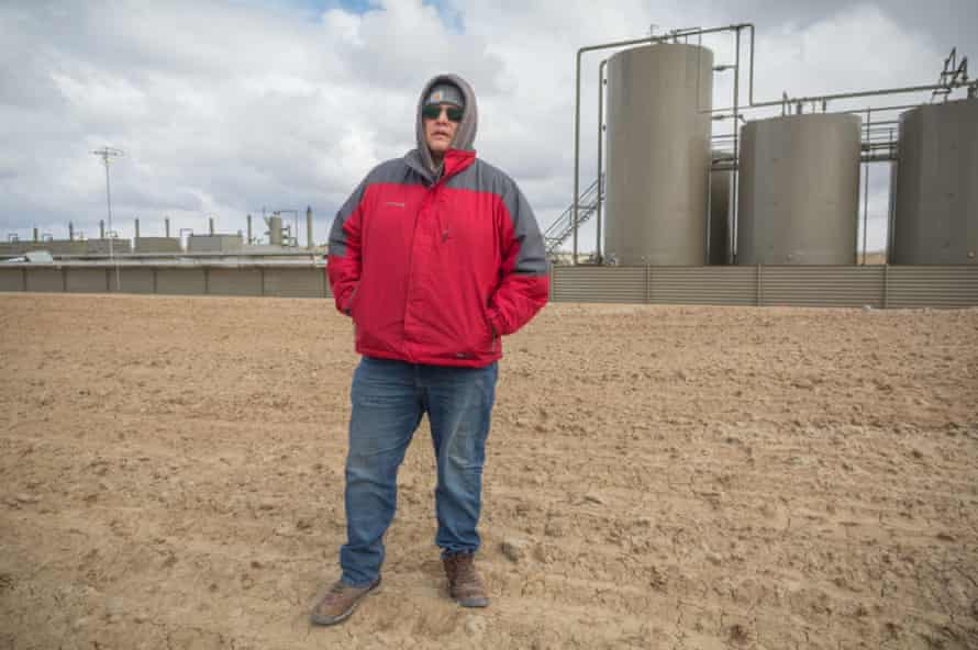 Mario Atencio stands in front of the wellsite that leaked fracking slurring into a wash near his grandmother's home in 2019. (C)2021/Jerry Redfern