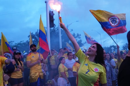 A supporter of De la Espriella lights a flare at a celebration rally after polls closed in the runoff election.
