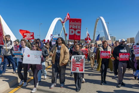 Activists march across the Fredrick Douglas Memorial Bridge on March 28, 2026 in Washington, DC.