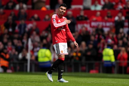Casemiro walks off the pitch after being substituted, gesturing to the club badge