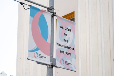 A light pink and blue banner reads ‘welcome to the transgender district’.