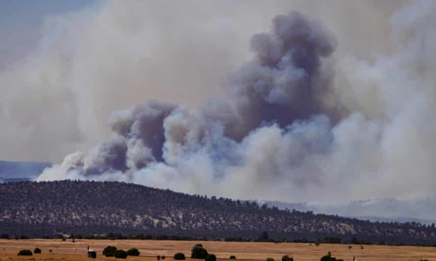 Smoke rises from wildfires near the city of Las Vegas, New Mexico