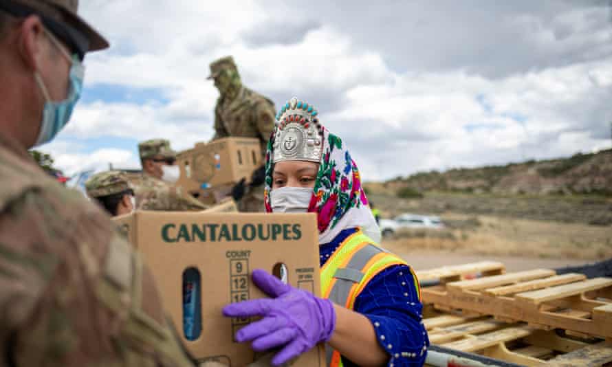 Miss Navajo Nation Shaandiin P Parrish grabs a box of food and other supplies to distribute to families on the Navajo Nation Reservation, New Mexico.