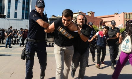 Turkish police detain two students during a protest in Diyarbakır