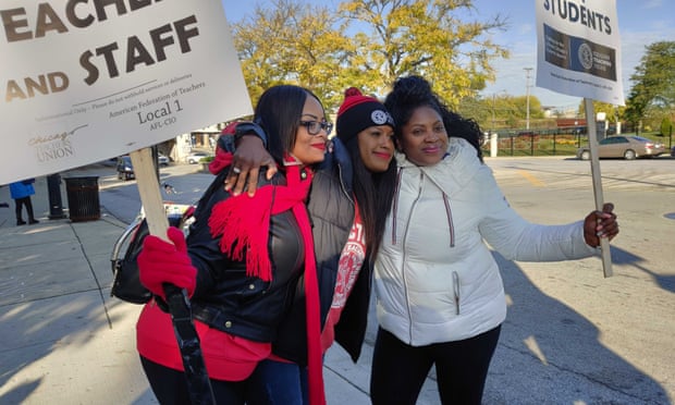 Chicago Teachers Union Vice President Stacy Davis Gates, center, poses with striking teachers on the picket line at National Teachers Academy